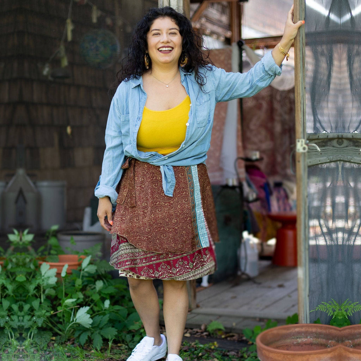 Knee-length mini sari wrap skirt by Darn Good Yarn in warm tones, featuring vibrant traditional fabric and stylish wrap design.