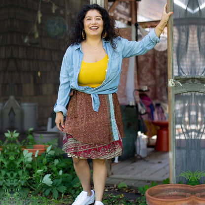 Knee-length mini sari wrap skirt by Darn Good Yarn in warm tones, featuring vibrant traditional fabric and stylish wrap design.