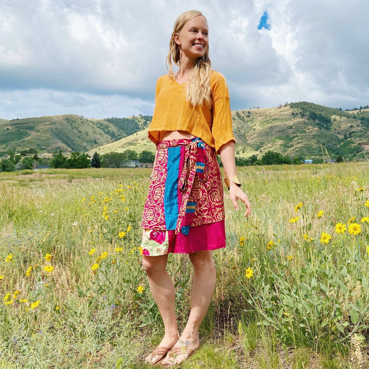 Knee-length mini sari wrap skirt in warm tones from Darn Good Yarn, showcasing vibrant fabric and traditional style.