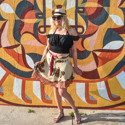 Knee-length Made With Love sari wrap skirt by Darn Good Yarn in warm tones, showcasing a vibrant, patterned Indian-inspired clothing accessory.