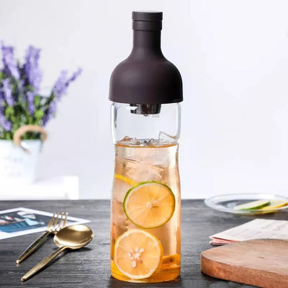 Nepal Tea Cold Brew Infuser Bottle with infuser chamber for making cold brew tea or coffee, clear glass design with black lid.