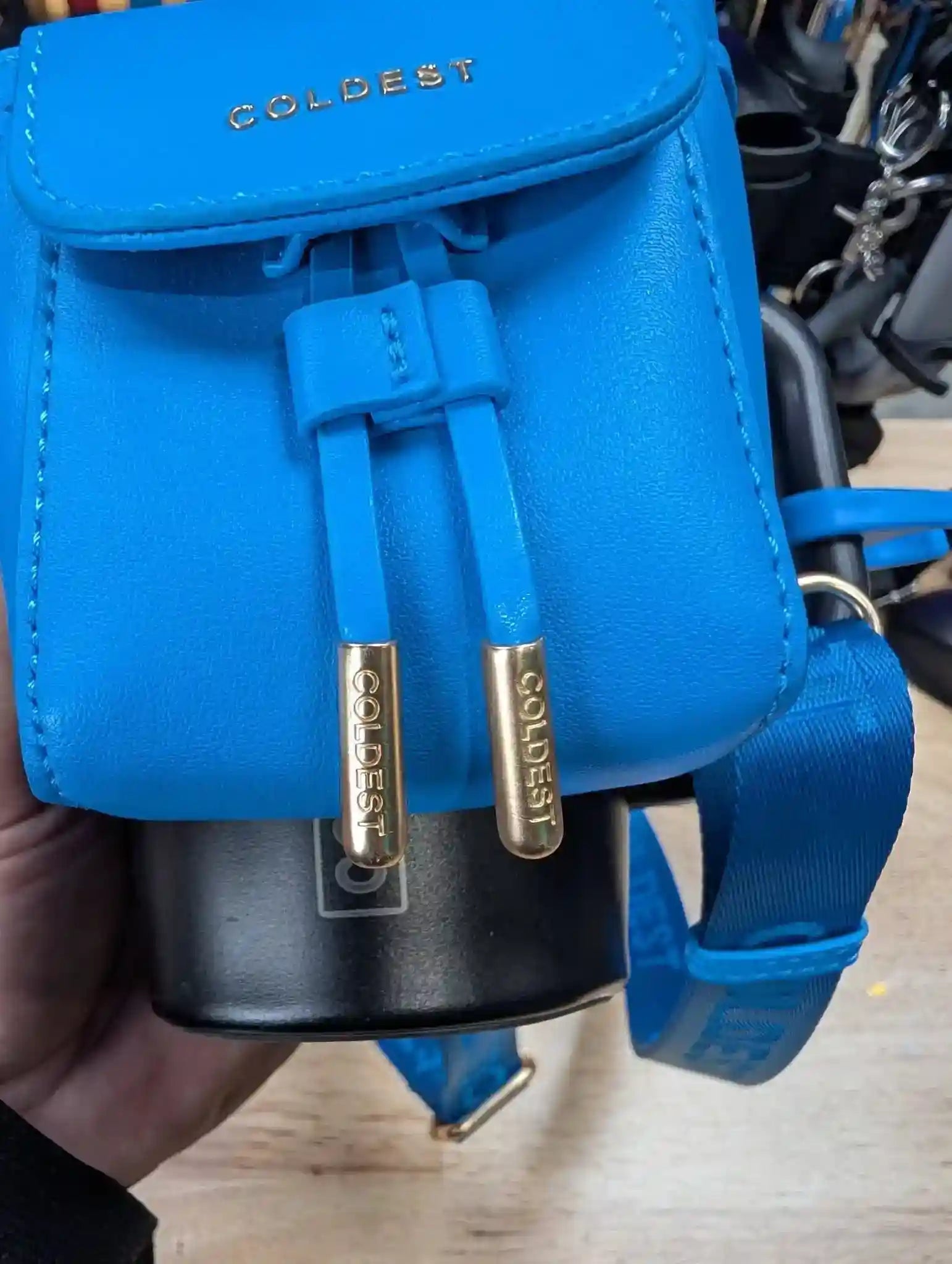 Coldest mini backpack and squeeze holder with key hanger and mint box in midnight black, compact and stylish for everyday use.