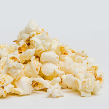 White cheddar popcorn by Colorado Popcorn Company in a 2 oz bag, showing crispy, cheesy popcorn kernels.