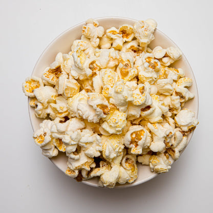 White cheddar popcorn from Colorado Popcorn Company, showing a close-up of fluffy, cheesy-coated popcorn kernels.
