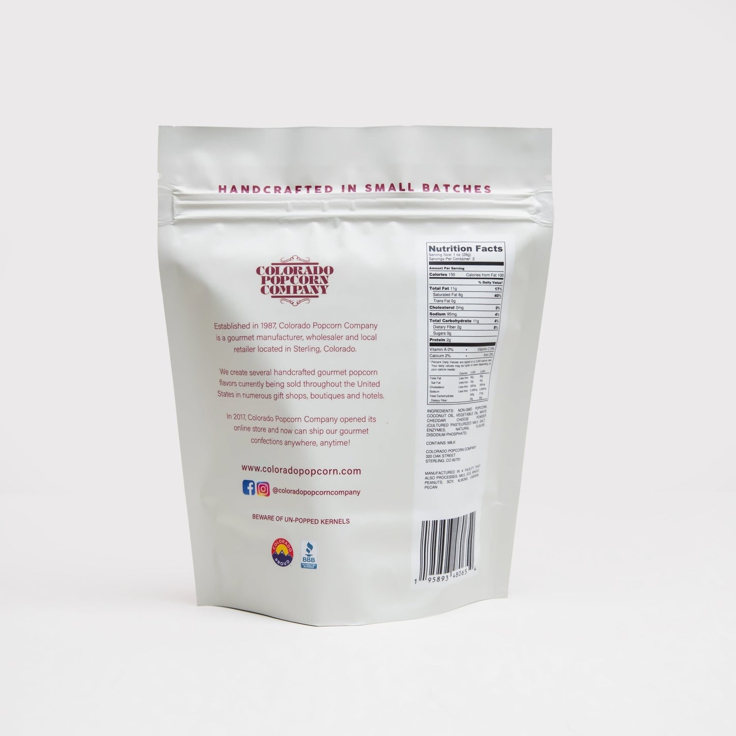 White cheddar popcorn by Colorado Popcorn Company in a 2 oz bag, showing golden popcorn coated with white cheddar seasoning.