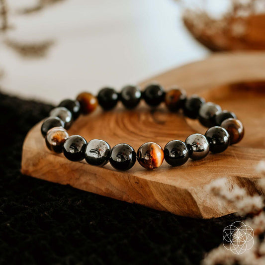 Conscious Items Triple Protection Bracelet featuring layered design with beads and charms on a neutral background.