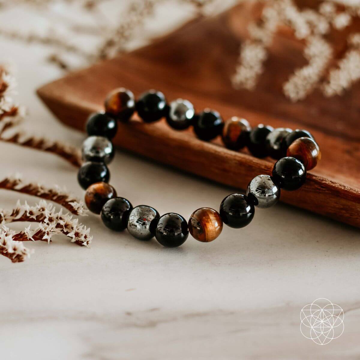 Conscious Items Triple Protection Bracelet featuring layered silver and black beads on a durable cord.