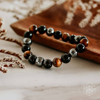 Conscious Items Triple Protection Bracelet featuring layered silver and black beads on a durable cord.