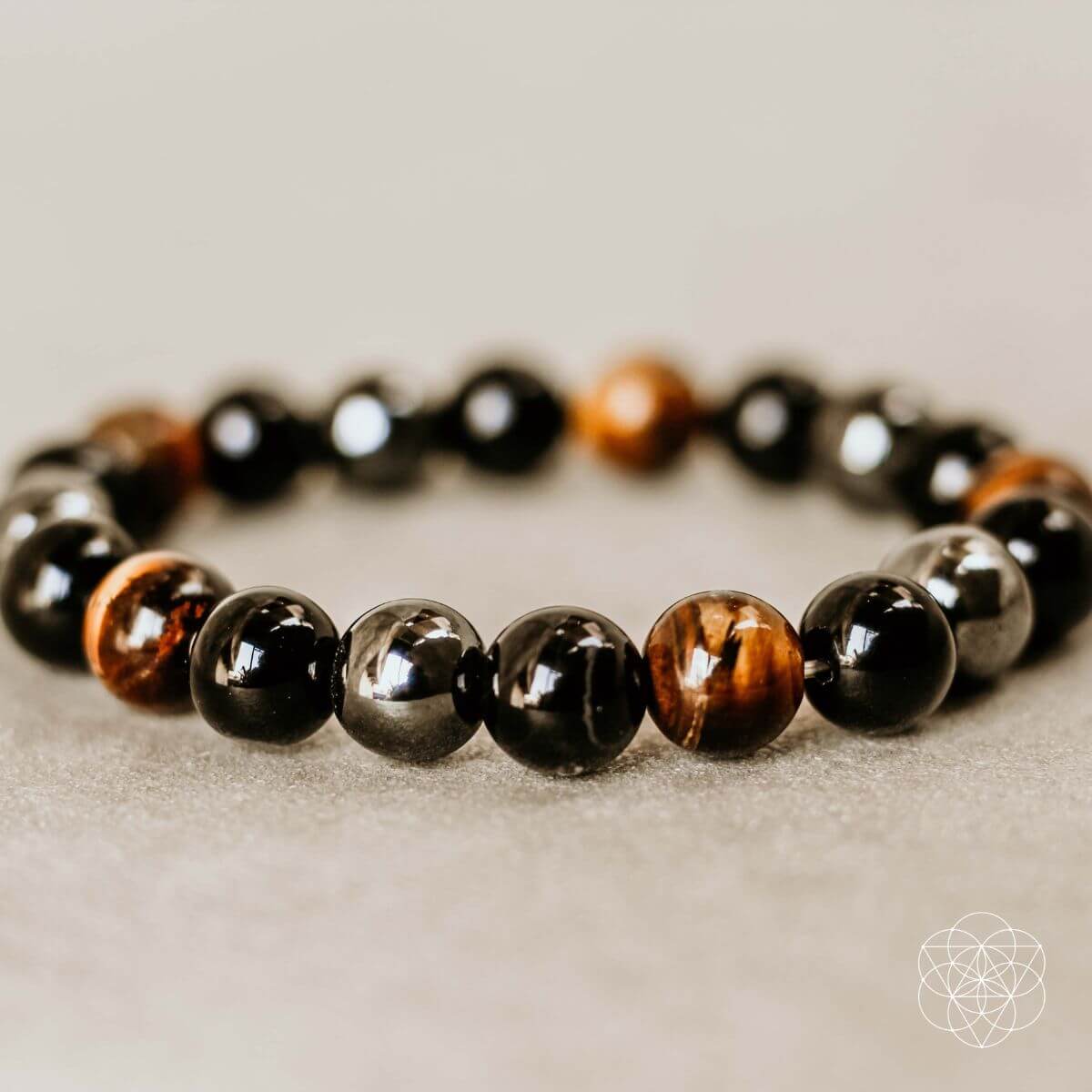 Conscious Items Triple Protection Bracelet featuring layered silver and black beads on a stretch cord.