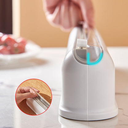 Wall-mounted cling film storage box with suction cups and adjustable cutter for kitchen use