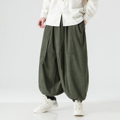 Men's loose-fitting harem pants with elastic cuffs, front and back view