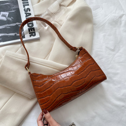 Women's small shoulder and underarm bag by BACKUPMYFILESNOW® featuring a sleek, simple design with a compact shape and adjustable strap.