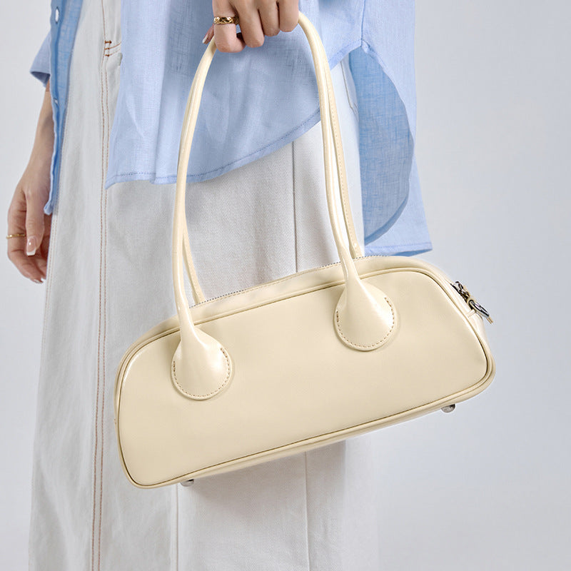 Women's minimalist genuine leather underarm bag in a sleek, compact design
