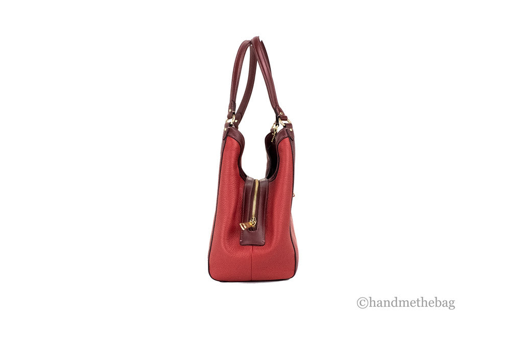 Coach Kristy red apple leather shoulder bag with triple compartments, featuring a stylish design and sturdy strap.