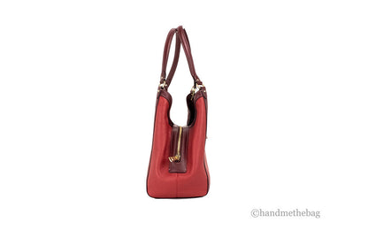 Coach Kristy red apple leather shoulder bag with triple compartments, featuring a stylish design and sturdy strap.