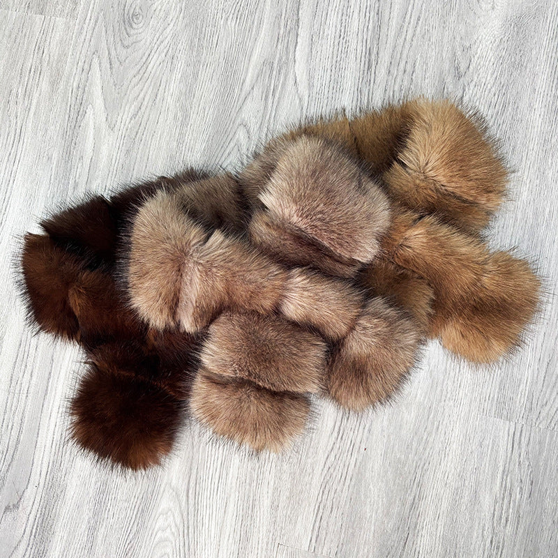 Segmented wool patches and plush materials cross-knitted into a mature, elegant coat with fur trim