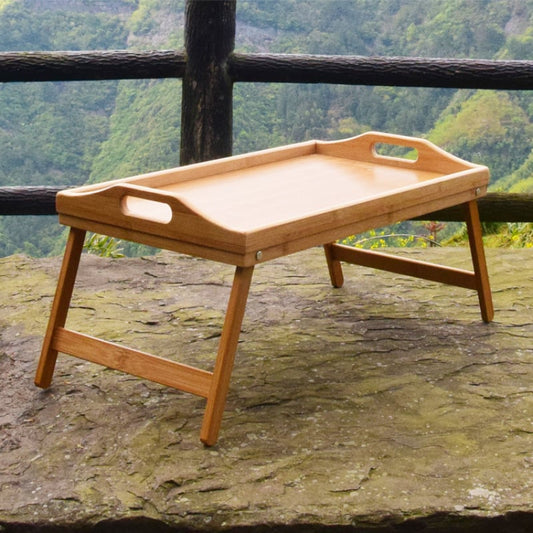 Bamboo folding breakfast tray with integrated feet, portable and lightweight for serving breakfast or snacks.