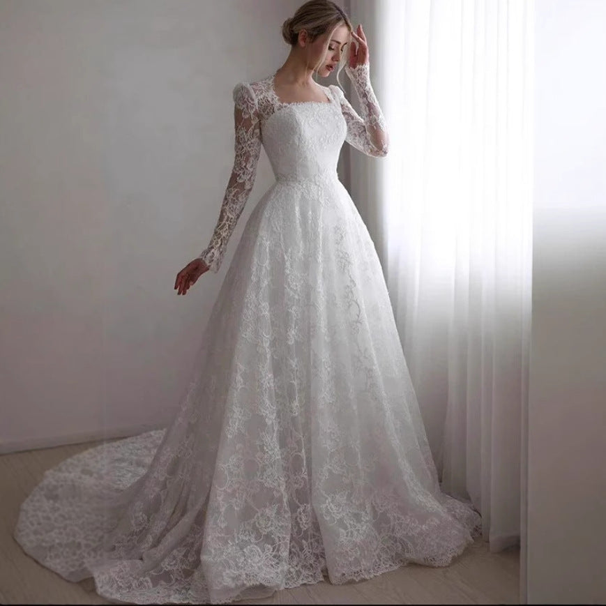 Embroidered long sleeve trailing wedding dress by My Store in an elegant bridal gown design