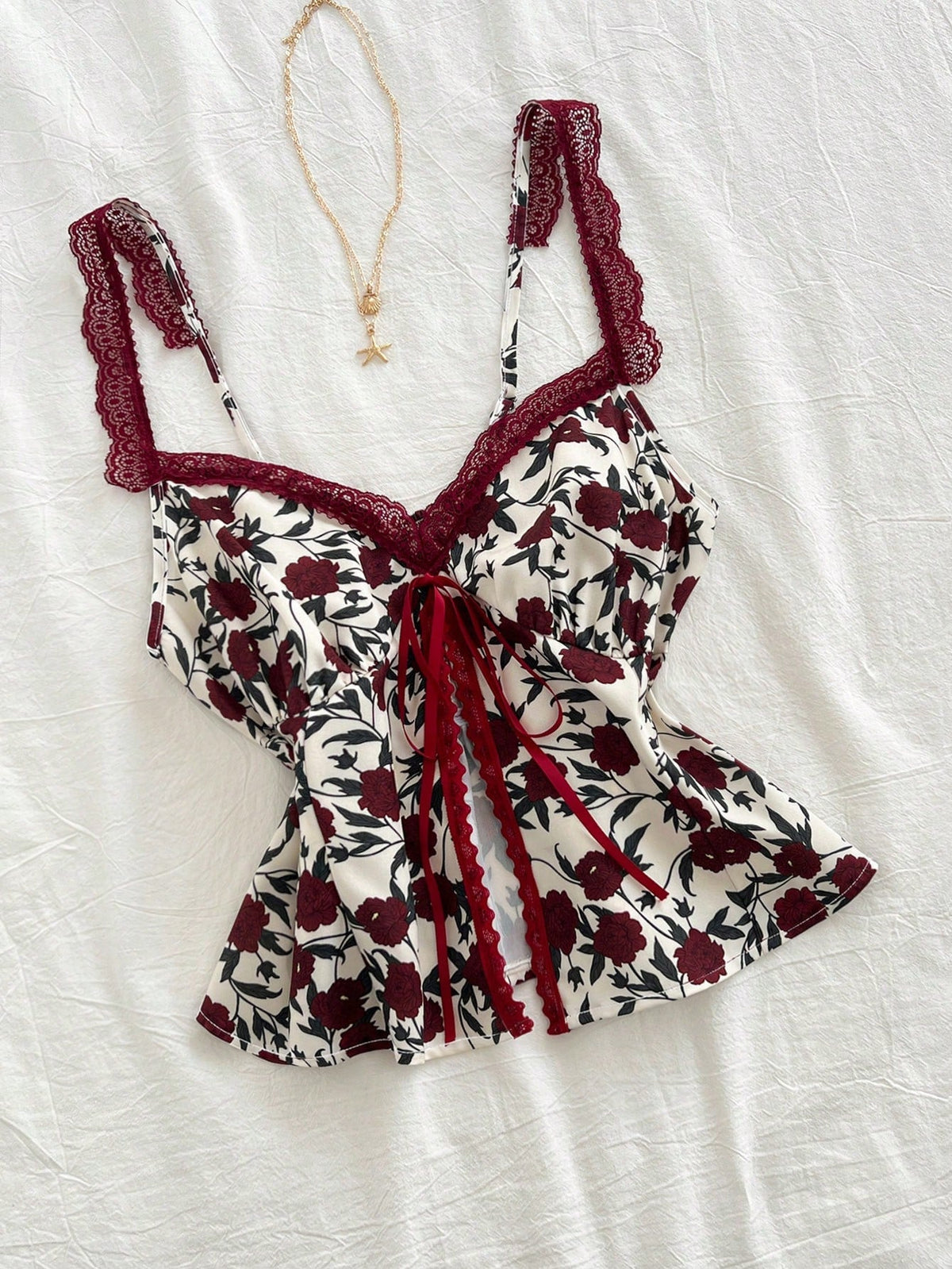 Lace-trimmed camisole with floral bow detail in a fashionable, versatile design