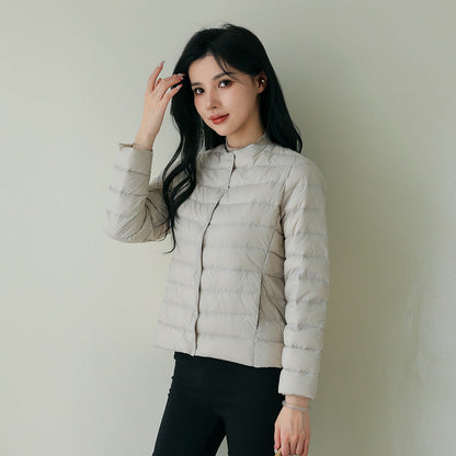 Women's lightweight white duck down jacket with quilted design and zip front