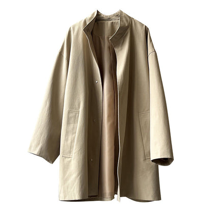 Japanese style women's workwear trench coat with stand collar and structured long silhouette