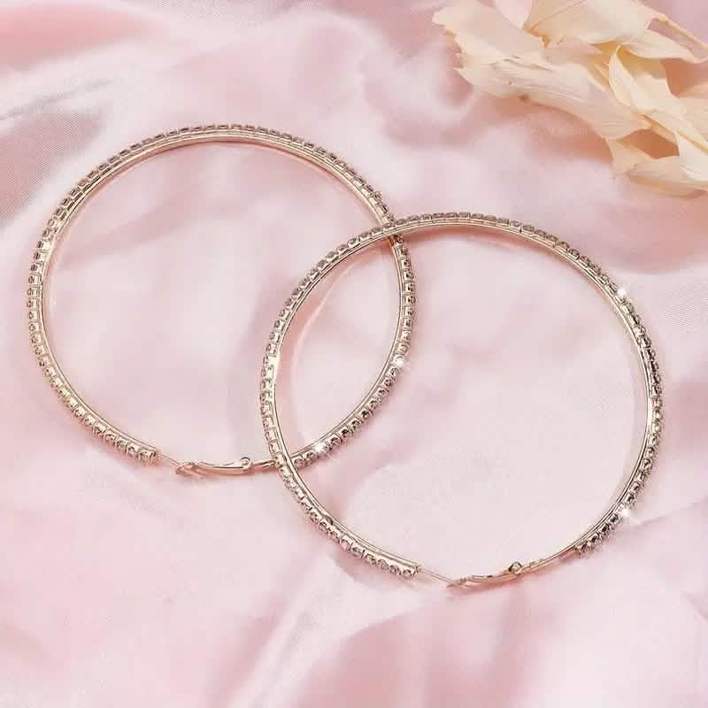 Large stainless steel gold rhinestone hoop earrings for women with bling design, stylish and eye-catching jewelry.