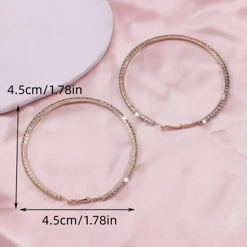 Large stainless steel gold hoop earrings with rhinestones, women's bling earrings featuring shiny, sparkling designs.