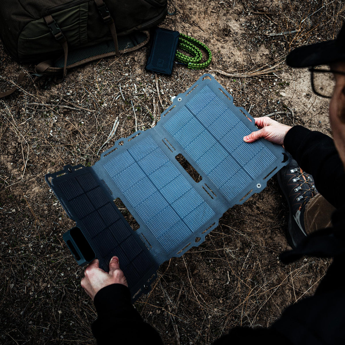 Dark Energy Spectre 18W solar panel showing a compact square solar panel with blue photovoltaic cells and black frame.