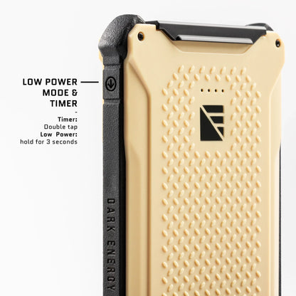 Dark Energy Poseidon Pro Power Bank portable charger in a desert setting, showing its compact design and rugged build.