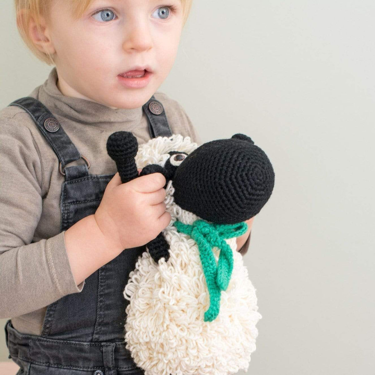 Black handmade organic cotton stuffed sheep named Shelly by Bebemoss, soft plush animal with detailed woolly texture.