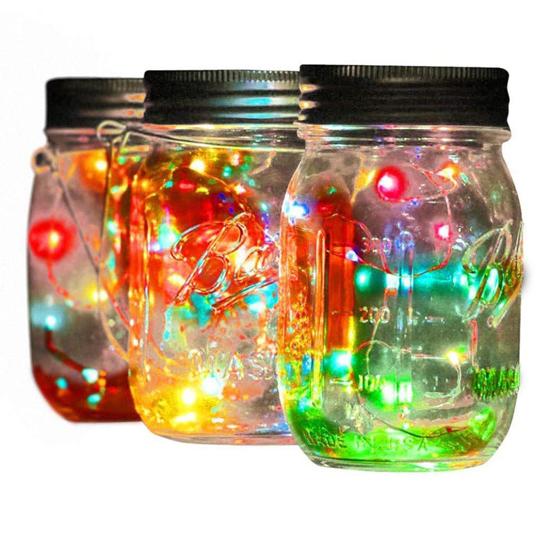 Solar mason jar light outdoor hanging decoration with string lights, shown in a clear glass jar