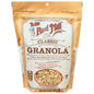 Bowl of Bob's Red Mill Classic Granola with oats, nuts, and dried fruit on a white background.