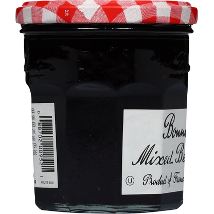 Jar of Bonne Maman Mixed Berries Preserves with a white lid and label showing fresh berries, on a wooden surface.