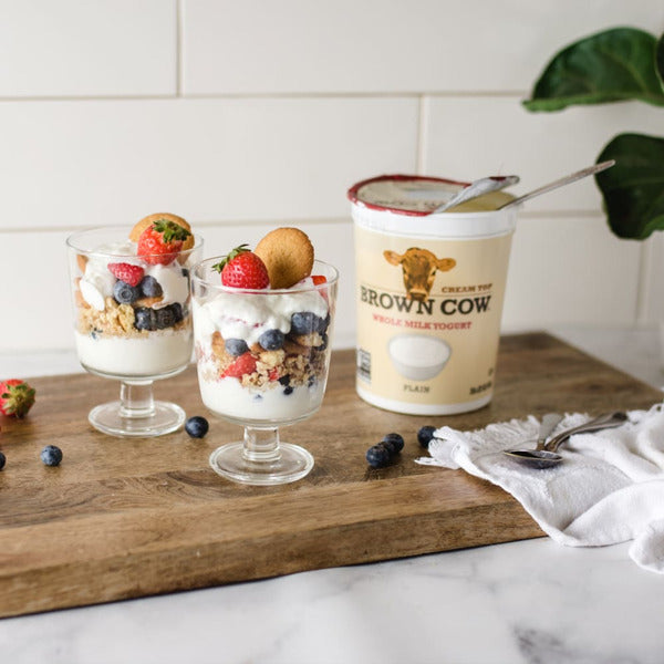 Brown Cow® Cream Top Whole Milk Yogurt with Maple flavor, creamy yogurt in a jar with a spoon.