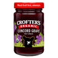 Jar of Crofter's Organic Concord Grape Premium Fruit Spread with fresh grapes and spreading on bread.