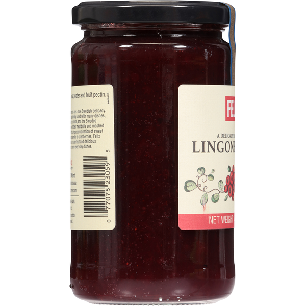 Fresh Felix Lingonberries in a clear glass bowl, showcasing vibrant red berries on a white background.