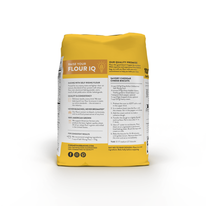 Bag of King Arthur Baking Company unbleached self-rising flour, non-GMO, preservative-free, in a natural paper bag.