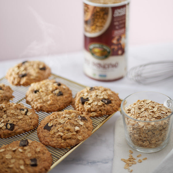 Bowl of Nature's Path Old Fashioned Oats Instant Oatmeal with a spoon on a wooden table, showcasing the breakfast cereal.