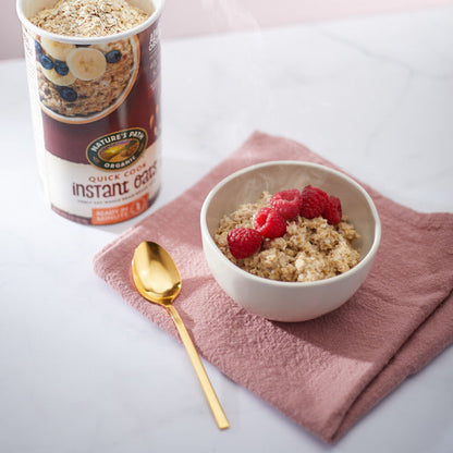 Organic quick oats from Nature's Path, in a clear bowl showing the light, rolled oats ready for breakfast or cooking.