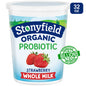 Stonyfield Organic Strawberry Whole Milk Probiotic Yogurt in a cup with fresh strawberries and yogurt swirls on top.