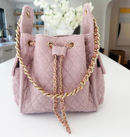 Small Bayshore Bucket by BEACH HAUS in dusty rose color, featuring a woven texture and sturdy handle for casual use.