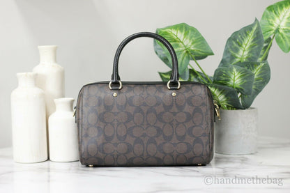 Coach Rowan Brown and Black Signature Leather Medium Satchel Handbag with top handles and gold-tone hardware.