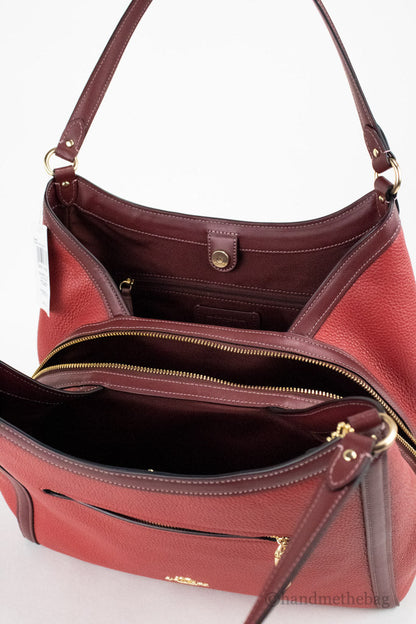 Coach Kristy red apple leather shoulder bag with triple compartments, stylish and spacious for everyday use.