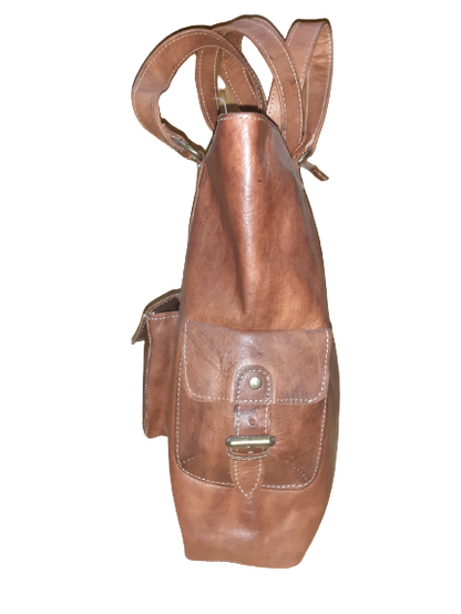 Handmade women's shoulder bag with a strap, featuring stylish craftsmanship and detailed leather design.
