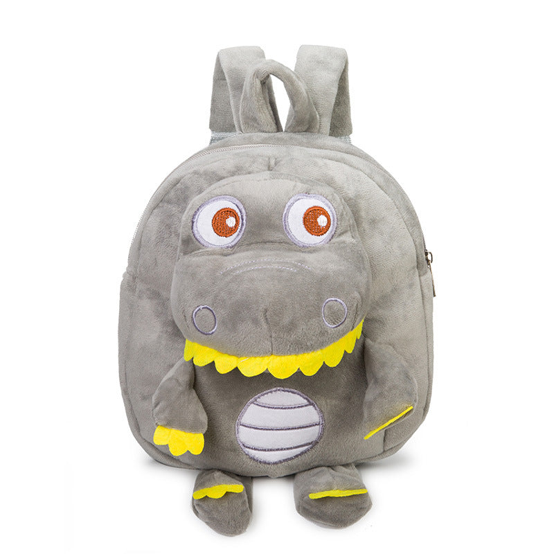 Baby dinosaur plush toy backpack in soft green fabric with playful dinosaur details