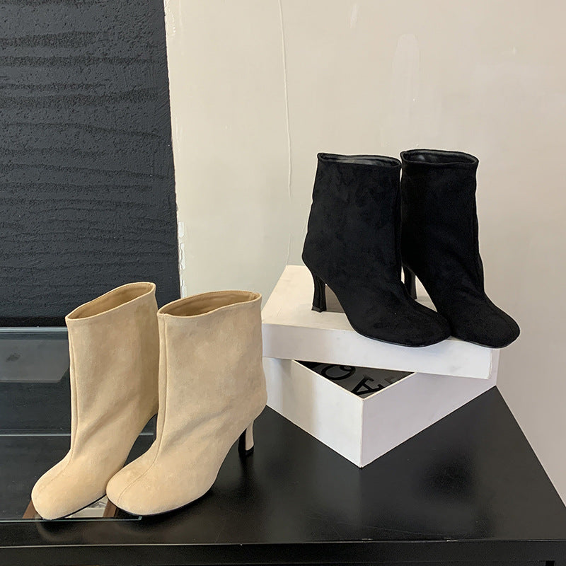 Versatile solid-color commuter-style booties with a low heel and ankle-height design