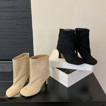 Versatile solid-color commuter-style booties with a low heel and ankle-height design