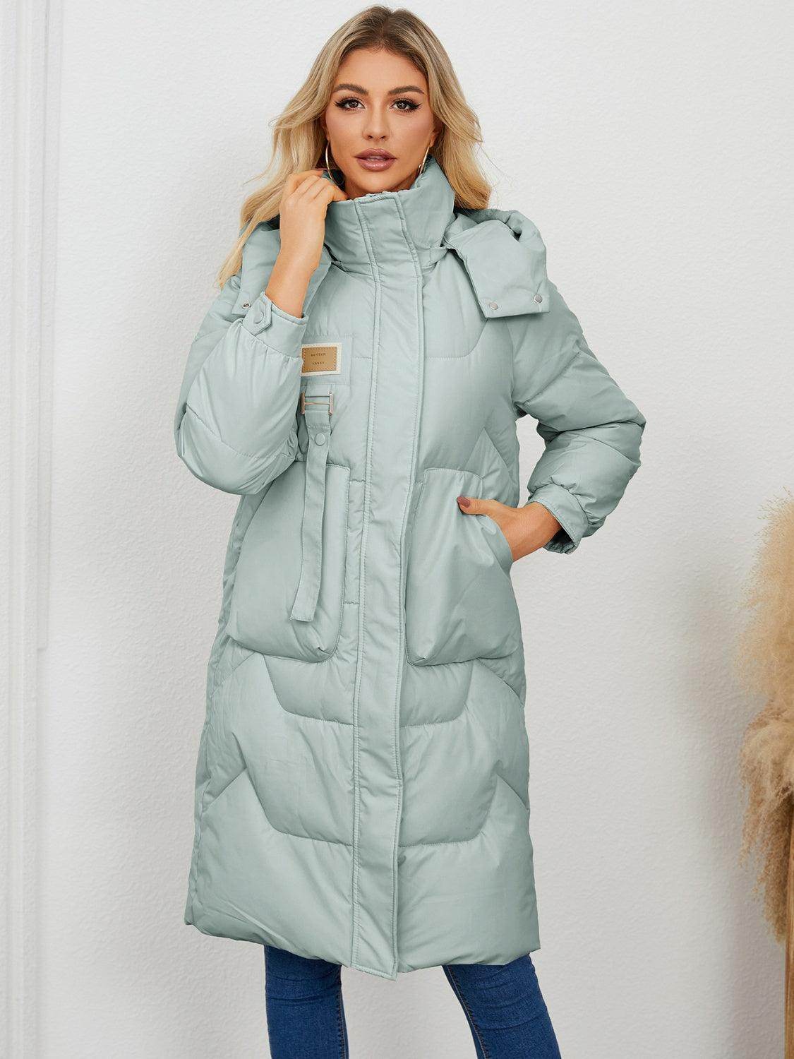 Long sleeve longline hooded winter coat for women by Trendsi, featuring a cozy fit and stylish design, shown in the image.
