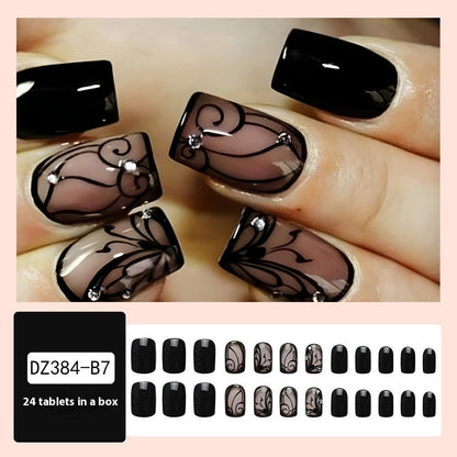 Black vine-inspired press-on nails with dark gothic design, close-up product image