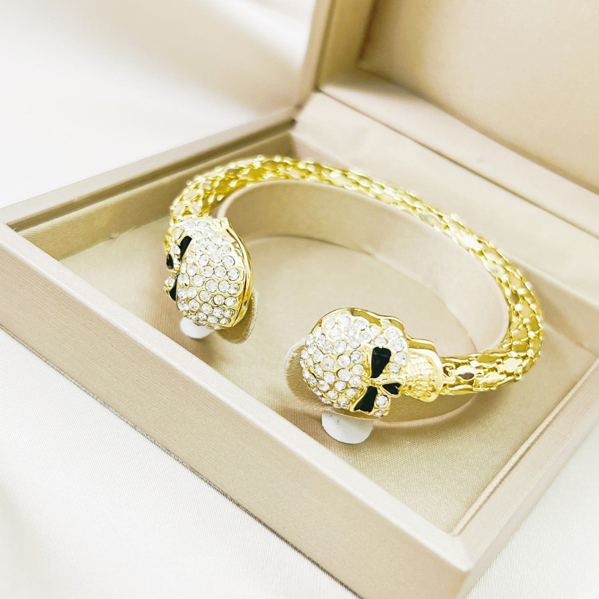 Golden skull open bangle studded with diamonds, shimmering light-luxury design